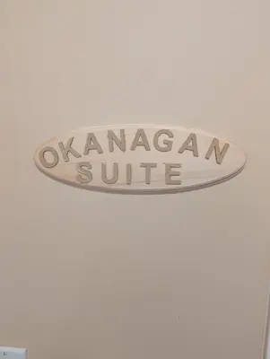 a sign for a surfboard hanging on a ceiling at Salish B&B and Spa in West Kelowna