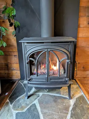 a wood stove is sitting in a room at 4 Mile Creek Cabin (Creekside) in Nelson