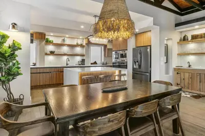 a kitchen with a large wooden table and chairs at Chalet Monashee - Brand New High-End Property with Amazing Views in Big White