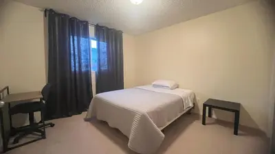 a small bedroom with a bed and a window at Private Rooms in a 3 Bedroom Guest House Close to Londonderry Mall 1 Person per Room No Couples For Men Only in Edmonton