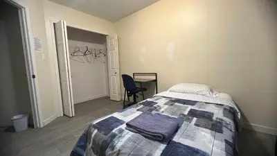 a bedroom with a bed and a desk and a chair at Private Rooms in a 3 Bedroom Guest House Close to Londonderry Mall 1 Person per Room No Couples For Men Only in Edmonton