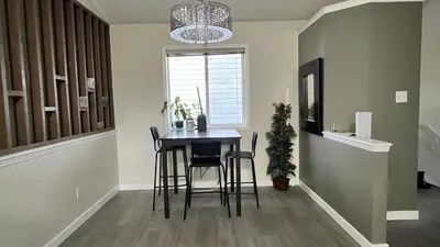 a dining room with a table and chairs and a window at Private Rooms in a 3 Bedroom Guest House Close to Londonderry Mall 1 Person per Room No Couples For Men Only in Edmonton