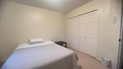 a small bedroom with a bed and a closet at Private Rooms in a 3 Bedroom Guest House Close to Londonderry Mall 1 Person per Room No Couples For Men Only in Edmonton