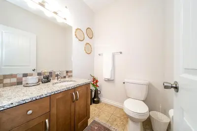 a bathroom with a toilet and a sink at Bali Style Home - King Bed - Fireplace - Jacuzzi - Fast Wi-Fi - Free Netflix & Garage Parking in Edmonton
