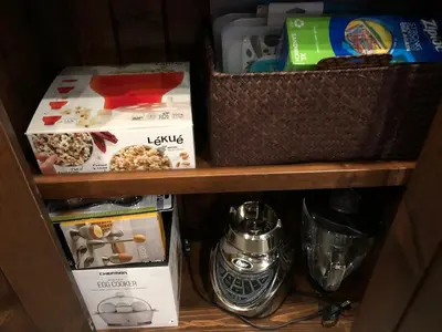 a shelf with boxes and other items on it at Blanchard Mountain BnB in Canmore
