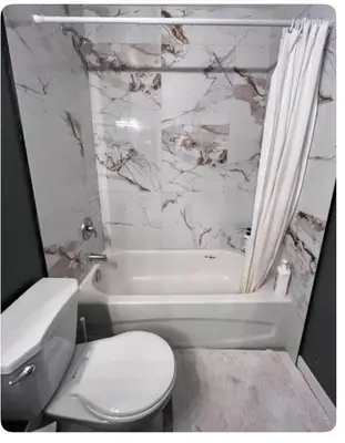 a white bathroom with a toilet and a tub and a sink at Banff mountain House&30 second Bus station Close C-Train& Free Parking in Calgary