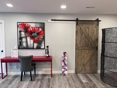 a room with a red desk and a wooden door at Banff Garden Suite&2mins Bus station Close LRT& Free Parking in Calgary
