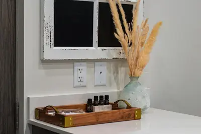 a shelf with a vase and a wooden tray with bottles at Vita Resort Vernon on Lake Okanagan in Vernon