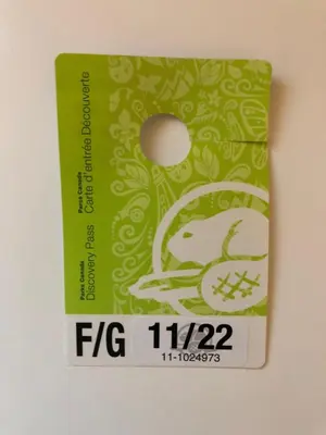 a green and white card with a logo on it at Mtn View Escape with King Size Bed with Outdoor Pool - Banff Pass Included! in Canmore
