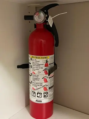 a red fire hydrant with a label on it at Mae Sweet Home in Surrey