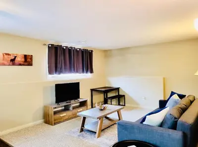 a living room with a couch and a table at Spacious Basement suite in Camrose