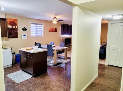 a kitchen and dining room with a table and chairs at Spacious Basement suite in Camrose