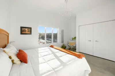 a large white bedroom with a large white bed at Carbon Valley Ranch in Grainger