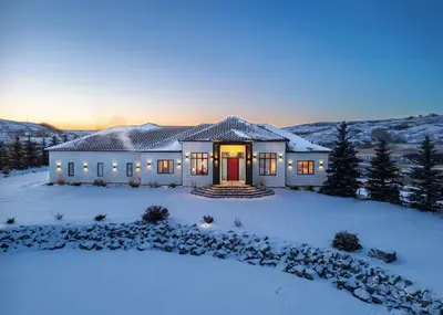 a house in the snow with lights on at Carbon Valley Ranch in Grainger