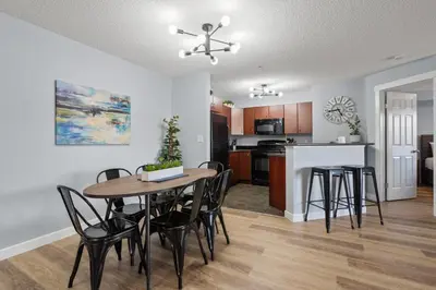 a kitchen and dining room with a table and chairs at The Altitude Landing, Pool, Hot Tub, Pets in Invermere