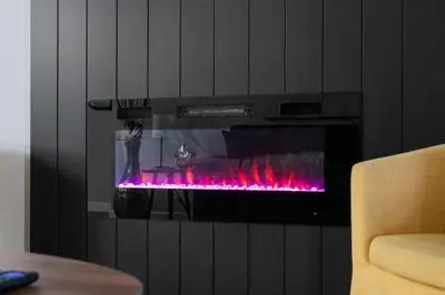a fireplace with pink flames in a living room at The Altitude Landing, Pool, Hot Tub, Pets in Invermere