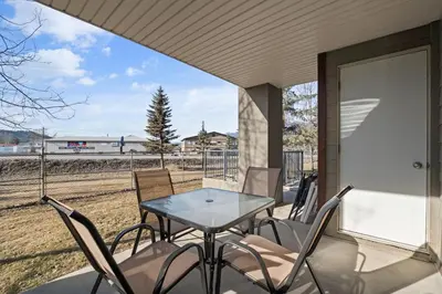 a table and chairs on a porch with a view of the tracks at The Altitude Landing, Pool, Hot Tub, Pets in Invermere
