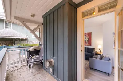 a sliding door leading to a kitchen and a living room at Granite Court by Outpost Whistler in Whistler
