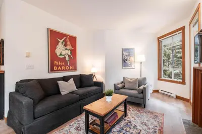 a living room with a couch and a table at Granite Court by Outpost Whistler in Whistler