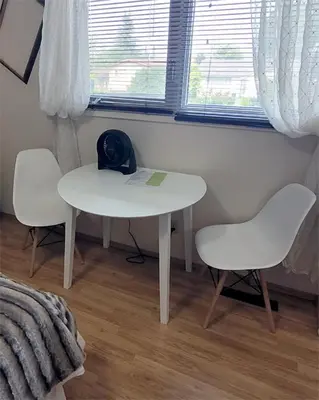 a white table and two chairs in a room at The Dewberry Homestay B&B in Edmonton