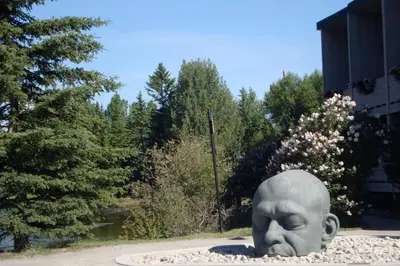 a statue of a head sitting in a park at Apartment 405 Bear Creek Crossing in Canmore