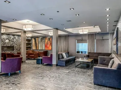 a lobby with couches and chairs in a building at Nature's Nook by Instant Suites Pool & HotTub in Canmore