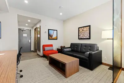 a living room with a couch and a table at Mountain View Inn & Suites in Sundre