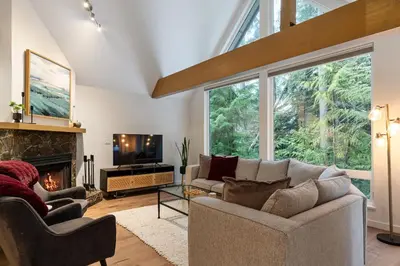 a living room with a couch and a fireplace at 3BR in Snowgoose, Ski In, Luxury Property, Free Shuttle to Lifts, Parking in Whistler