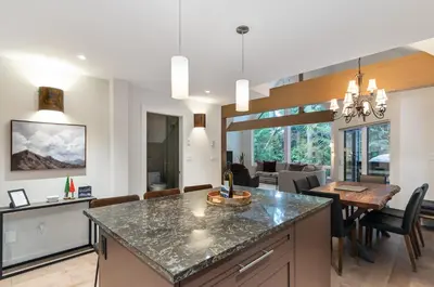 a kitchen and dining room with a dining table at 3BR in Snowgoose, Ski In, Luxury Property, Free Shuttle to Lifts, Parking in Whistler