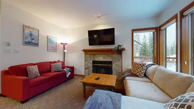 a living room with two couches and a fireplace at 2BR in Painted Cliff, Ski In, Ski Out, Communal Hot Tub, Wood Burning Fireplace, Free Parking in Whistler