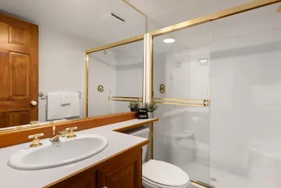 a bathroom with a sink and a toilet and a shower at 2BR in Painted Cliff, Ski In, Ski Out, Communal Hot Tub, Wood Burning Fireplace, Free Parking in Whistler