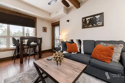 a living room with a couch and a table at Heavenly Mountain Hideaway, Pool, Hot Tub in Radium Hot Springs