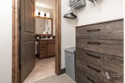 a bathroom with a wooden dresser and a sink at Heavenly Mountain Hideaway, Pool, Hot Tub in Radium Hot Springs