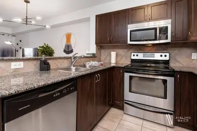 a kitchen with a stove and a microwave at Chic Retreat, Modern, Pool, Hot Tub, Gym in Invermere