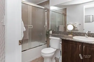 a bathroom with a toilet and a shower and a sink at Chic Retreat, Modern, Pool, Hot Tub, Gym in Invermere