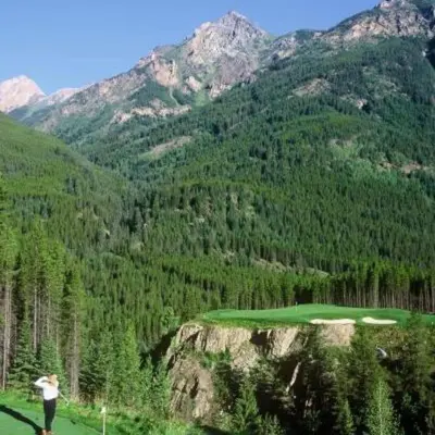 a woman standing on top of a golf course at Chic Retreat, Modern, Pool, Hot Tub, Gym in Invermere