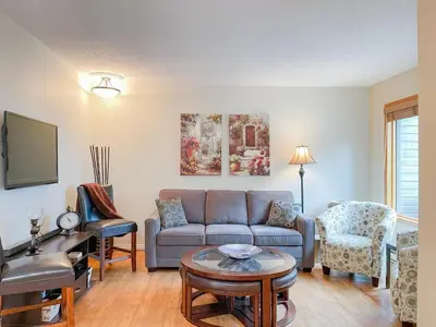 a living room with a couch and a table at Radium Villas in Radium Hot Springs