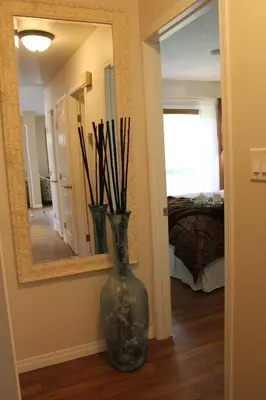 a vase sitting on the floor in front of a mirror at Radium Villas in Radium Hot Springs