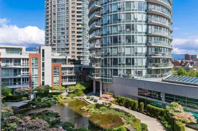 a view of a city with tall buildings and a garden at Beautiful 1 BR in the Heart of Downtown: Parking, Pool & Gym in Vancouver