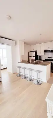 a white kitchen with a counter and a sink at Beautiful 1 BR in the Heart of Downtown: Parking, Pool & Gym in Vancouver