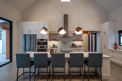 a kitchen with a large kitchen island with chairs at Revelstoke Modern Farmhouse in Revelstoke