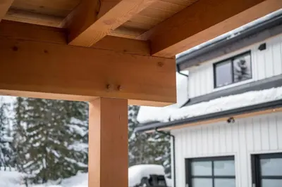 a wooden pergola in front of a house at Revelstoke Modern Farmhouse in Revelstoke