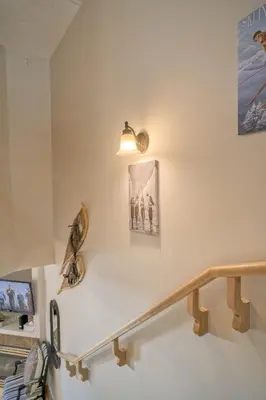 a stairway with a light and a railing at Incredible Mountain View Townhouse in DT Canmore w/ A/C & U/A Parking in Canmore