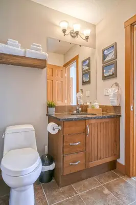a bathroom with a toilet and a sink at Incredible Mountain View Townhouse in DT Canmore w/ A/C & U/A Parking in Canmore