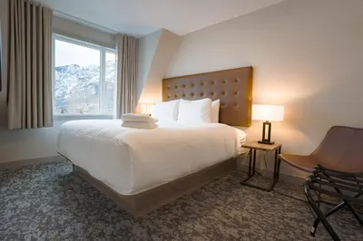 a hotel room with a bed and a window at Basecamp Suites Banff in Banff