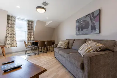a living room with a couch and a table at Basecamp Suites Banff in Banff