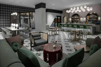 a restaurant with couches and tables and a bar at The Dorian, Autograph Collection in Calgary