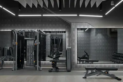 a gym with several tread machines and a mirror at The Dorian, Autograph Collection in Calgary