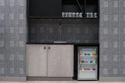a kitchen with an open refrigerator next to a wall at Courtyard by Marriott Calgary Downtown in Calgary