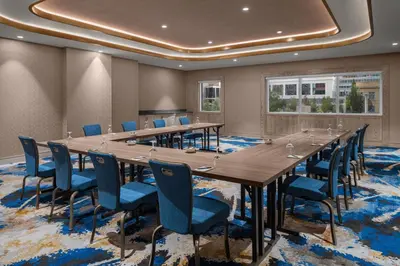 a large conference room with a long table and chairs at Courtyard by Marriott Calgary Downtown in Calgary